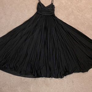 BLACK EVENING DRESS WITH LOTS OF PLEATS.